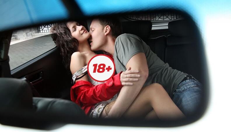 Couple kissing before having sex inside a car
